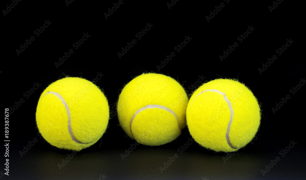 Yellow felt tennis balls on black background. Tennis ball photo for banner template. Summer sport activity