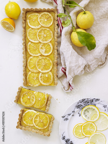 Overhead view of baked lemon pie slices against white background