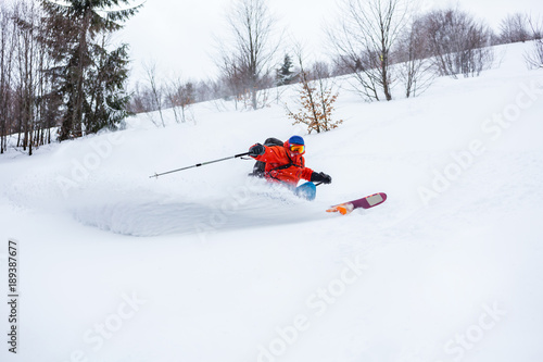 A skier is riding fast in fresh powder.Good powder day in Carpathians.