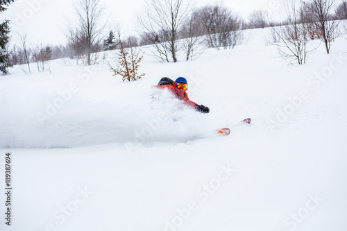 A skier is riding fast in fresh powder.Good powder day in Carpathians.