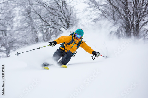 Schilderij op canvas A skiier is riding down the hill
