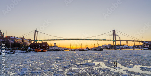 Gothenburg - Beautiful sunset at frozen Gota river with Hisingsleden Bridge in the harbor district during winter