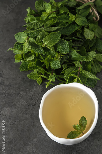 Fresh mint leaves in tea. Italian herbs. Dark background. © naltik