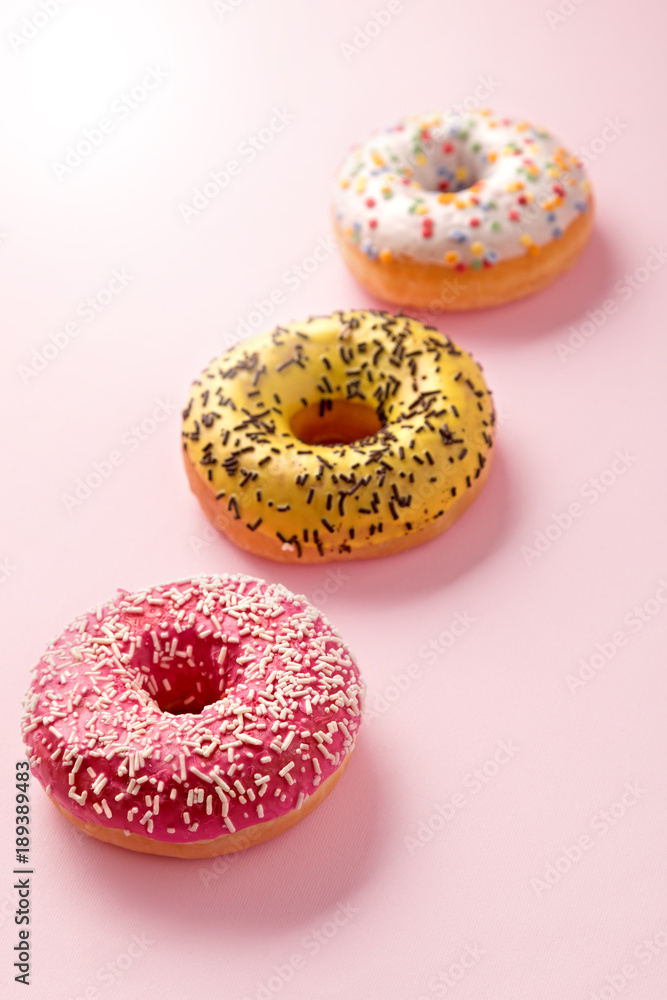 Donuts selection on pink pastel background. Various doughnuts isolated on colorful background Donuts selection on pink pastel background. Various doughnuts isolated on colorful background