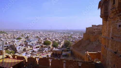 Fort walls and towers of the famed jaisalmer fort in India. The curved sandstone walls with small windows and huge towers make this a perfect seige fort. The still living fort now houses a museum photo