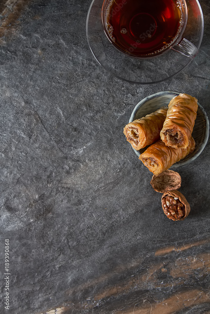 Traditional eastern arabic dessert Baklava with Turkish honey and walnuts, selective focus. Copy space. Top view