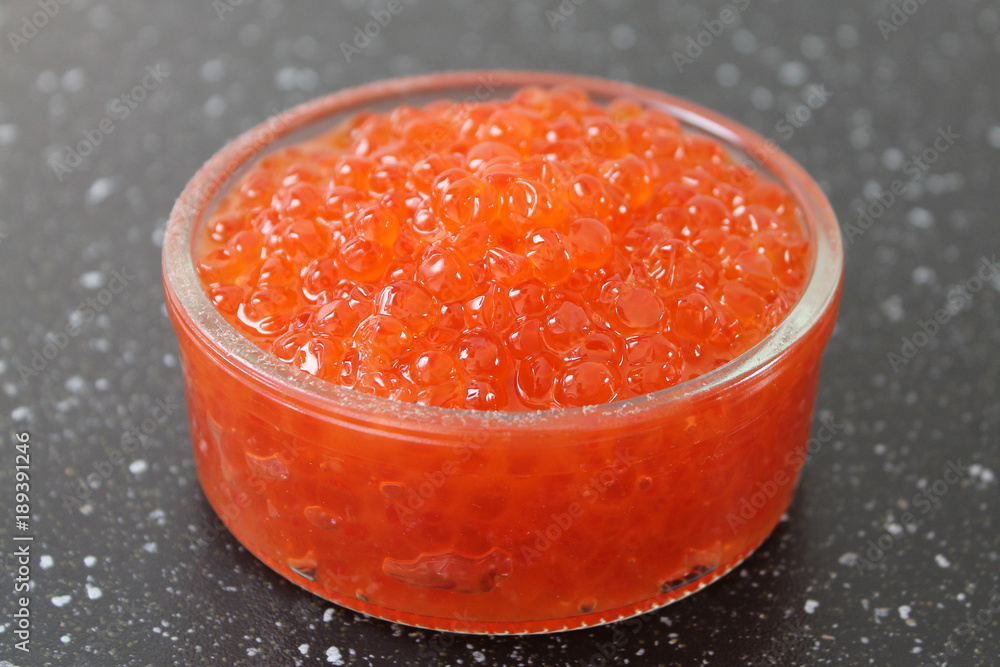 Glass bowl with red salmon caviar. Traditional russian food. Glass bowl with red salmon caviar. Traditional russian food.