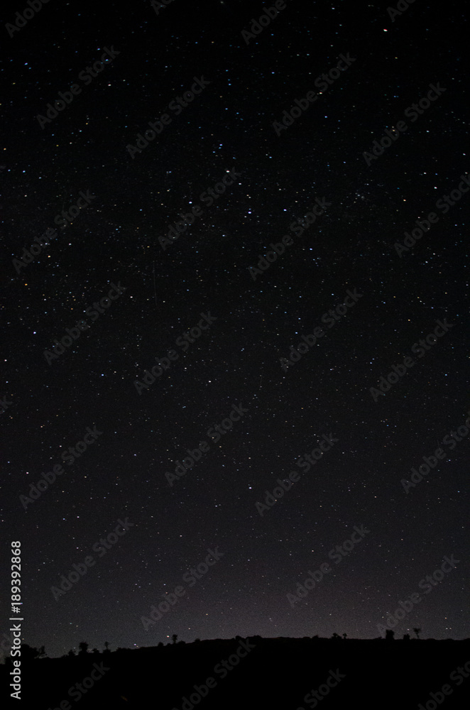 Nighttime sky with stars above horizon in Oman