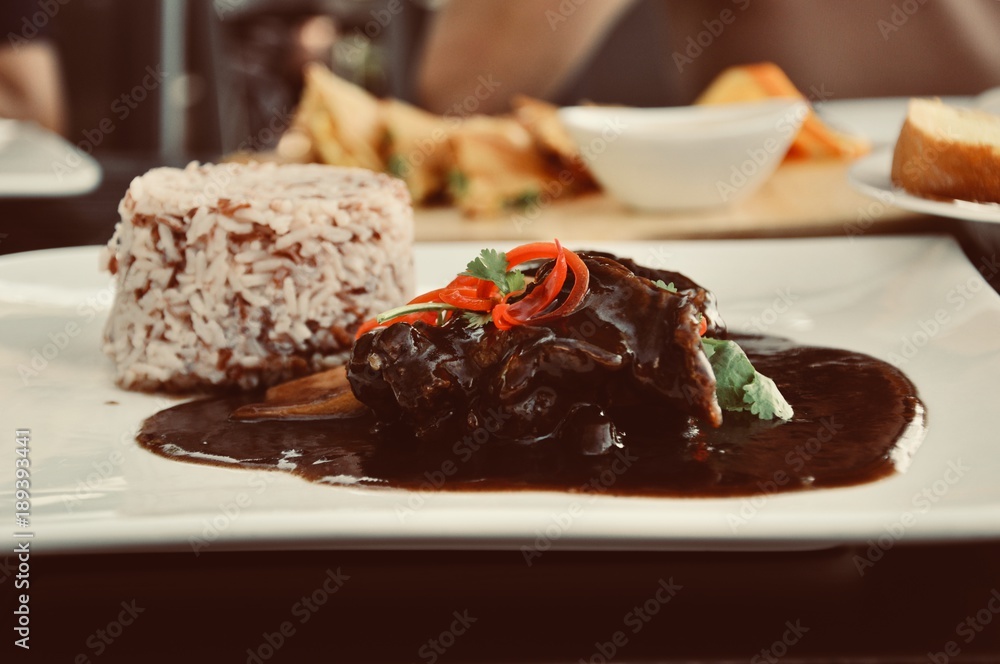 meat grilled with fresh vegetable salad and brown rice on a white plate. a top view of a horizontal, food decoration concept meat grilled with fresh vegetable salad and brown rice on a white plate. a top view of a horizontal, food decoration concept