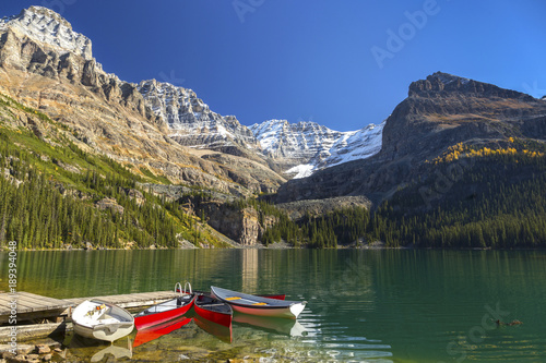 Canoe Boats and Distant Mountain Tops Autumn Landscape at Lake O’Hara Yoho National Park British Columbia Canada