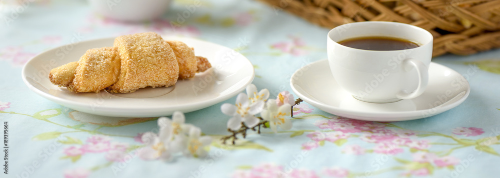 Many croissants on a table with spring flowers Many croissants on a table with spring flowers