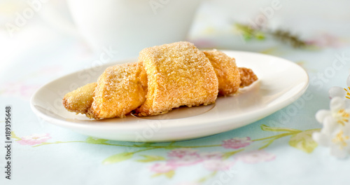 Many croissants on a table with spring flowers