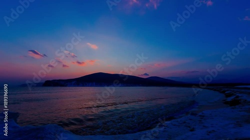 Winter sunset on the wild coast, ice figures, rays from the sun. The Sikhote-Alin Nature Reserve, a biosphere reserve in Russia. photo