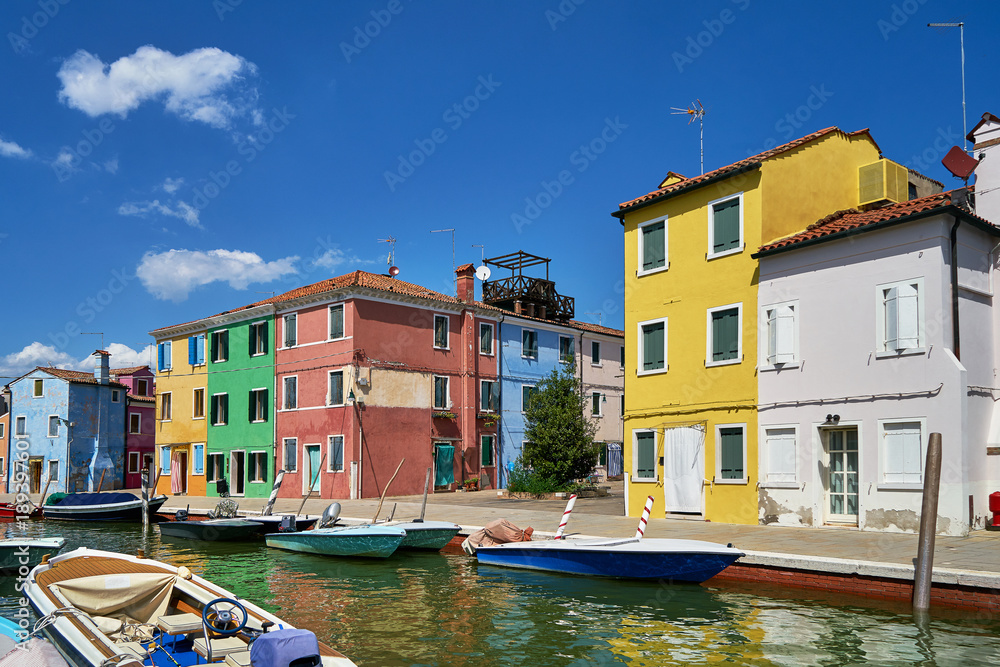 Burano, Venice. Colorful houses architecture, Burano island canal and boats. Summer 2017, Italy
