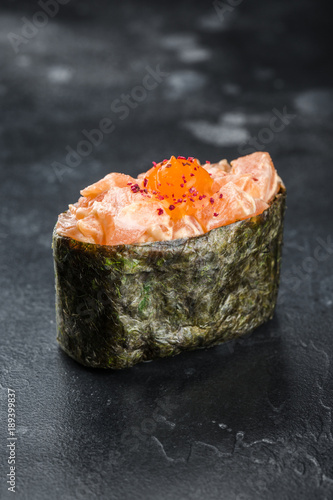Gunkan maki sushi with salmon on black background