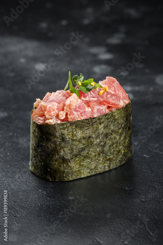 Gunkan maki sushi with tuna on black background