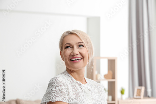 Portrait of emotional mature woman at home