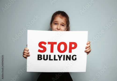 Little girl holding sign wi...