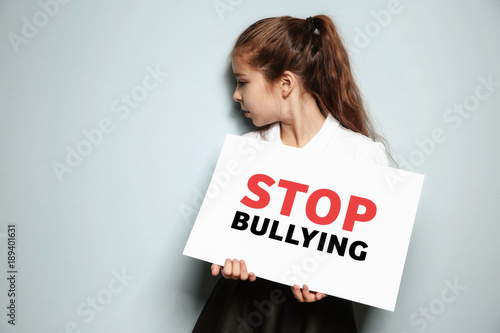 Little girl holding sign wi...
