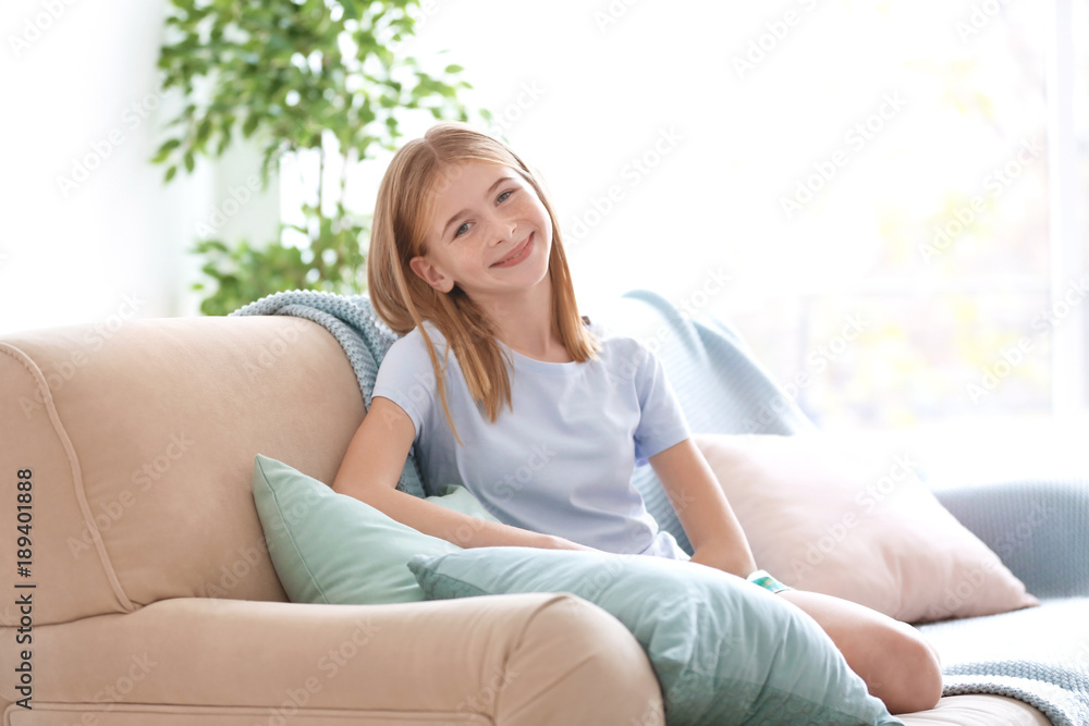 Cute girl resting on couch with soft pillows Cute girl resting on couch with soft pillows