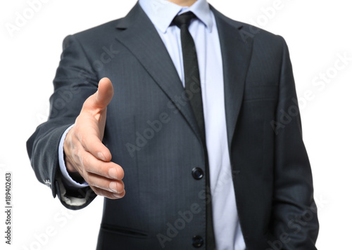 Car salesman stretching hand for handshake, on white background