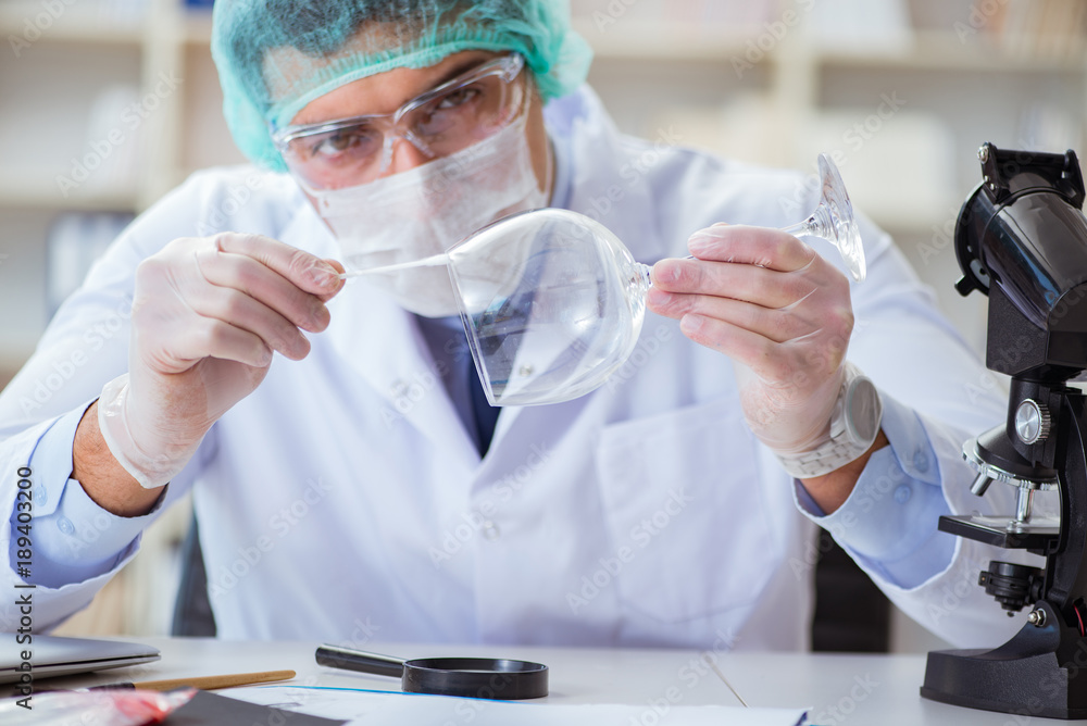 Forensics investigator working in lab on crime evidence Forensics investigator working in lab on crime evidence