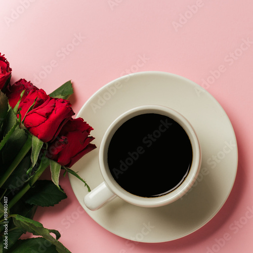 Morning concept background with rose and a cup of coffee. Top view with space for your text