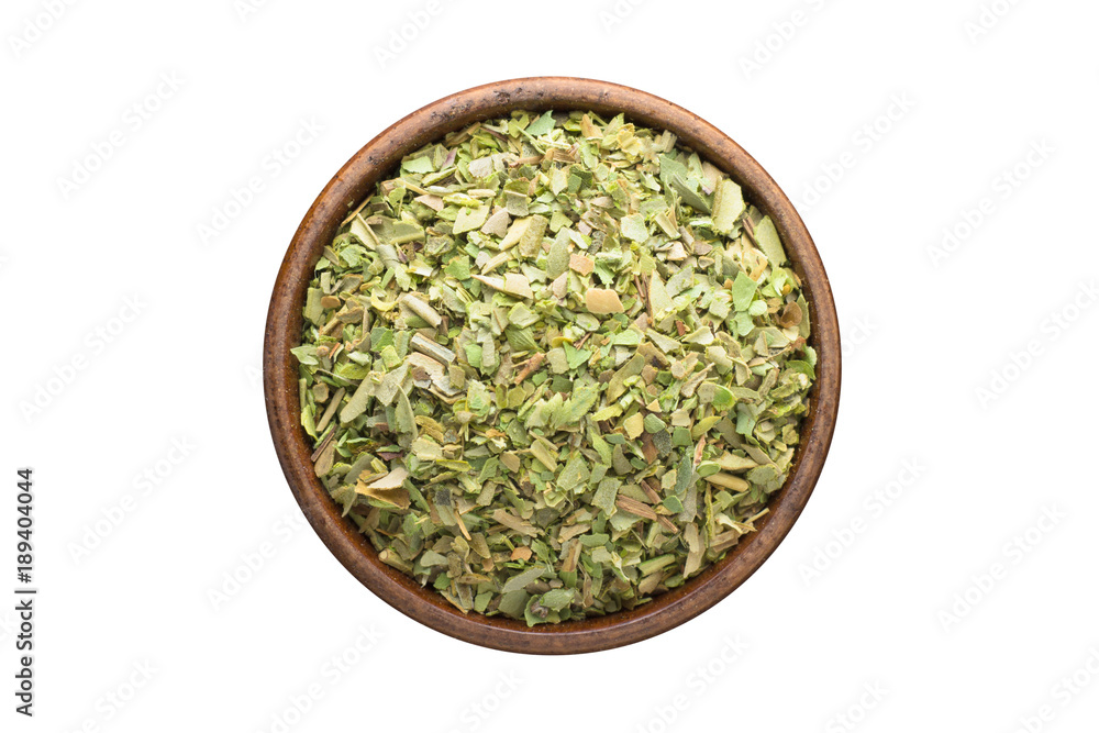 dried oregano spice in wooden bowl, isolated on white background. Seasoning top view dried oregano spice in wooden bowl, isolated on white background. Seasoning top view