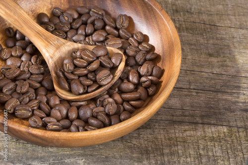 Roasted coffee on the wooden background - Coffea