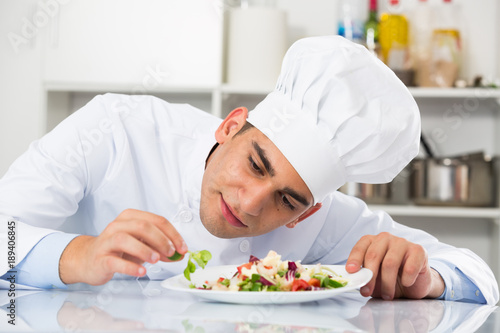 Chef is degustating salad