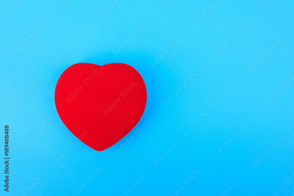 Fototapeta premium one bright red heart on a blue background