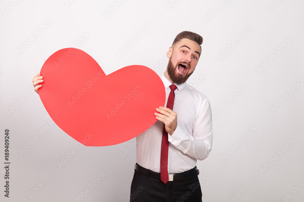 Funny businessman toothy smiling, holding big red heart Funny businessman toothy smiling, holding big red heart