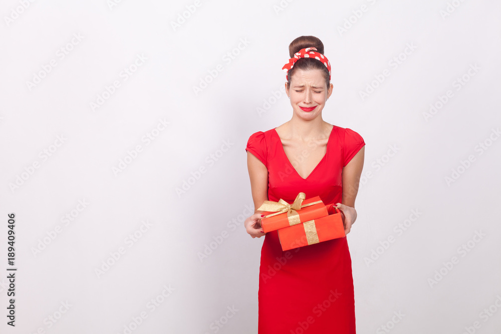Disappointment. Woman holding red box and cry. Bad gift Disappointment. Woman holding red box and cry. Bad gift