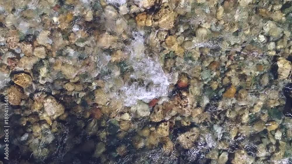 Flight over clear water flowing along the stony bottom of the river Tara. Montenegro. Flight over clear water flowing along the stony bottom of the river Tara. Montenegro.