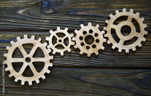 gears on a wooden background. The concept of business, creative, logical thinking. Teamwork. Logical background. gears of natural wood. photo