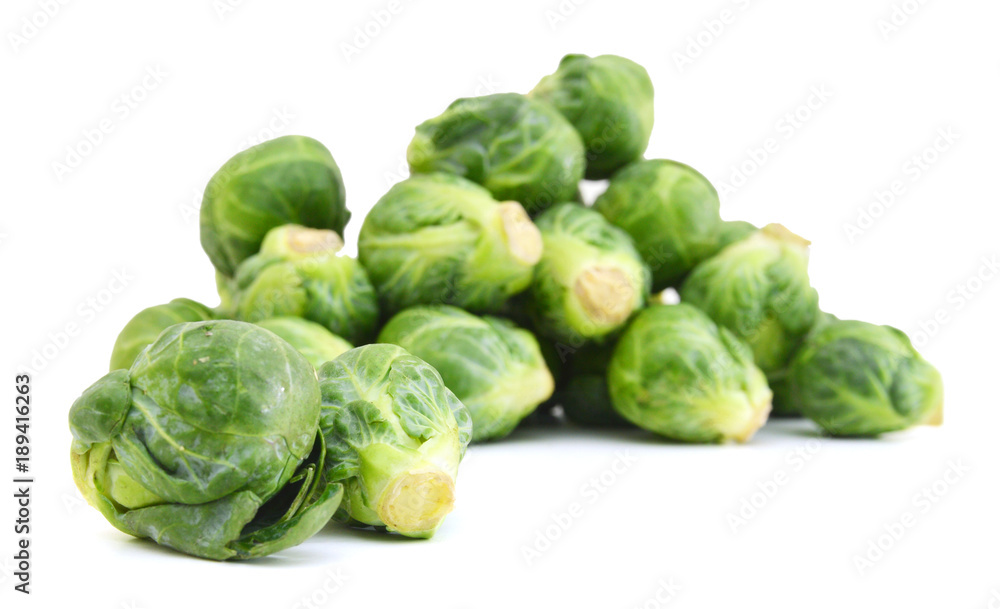 freshly brussel sprouts and some whole ones on a white background freshly brussel sprouts and some whole ones on a white background