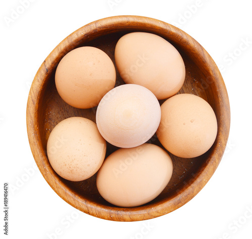 Eggs in wooden bowl on white background