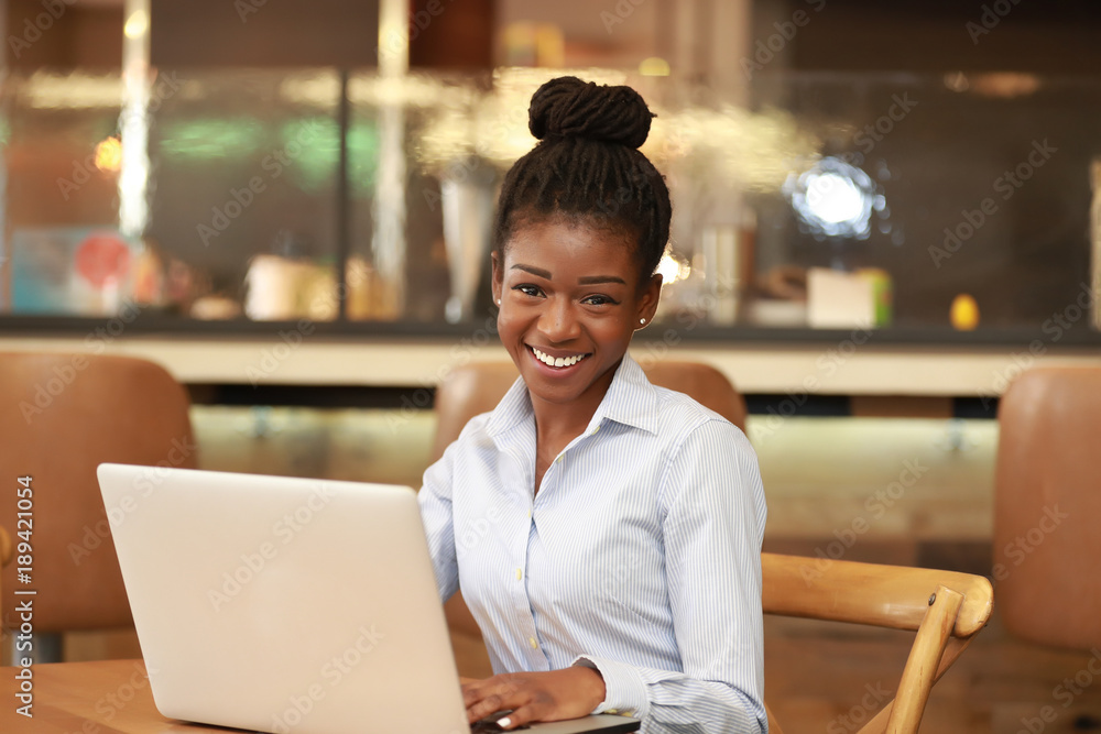 Excited young black woman with laptop Stock Photo Adobe Stock