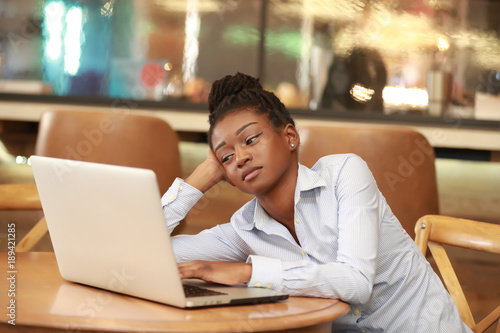Casual black woman with laptop at table Free Download Casual black woman with laptop at table - GFXLoad
