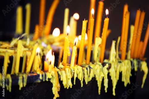 yellow candle with beautiful candle dripping background.