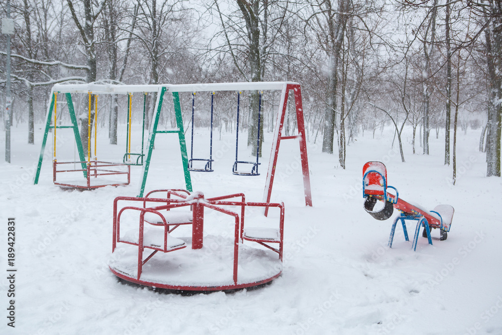 white snow and playground. playground in the snow in winter during a blizzard white snow and playground. playground in the snow in winter during a blizzard