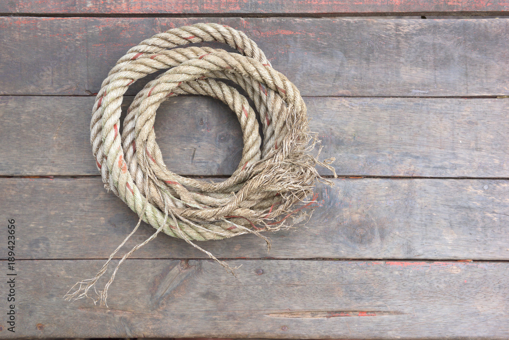 The rope rests on a wooden background.