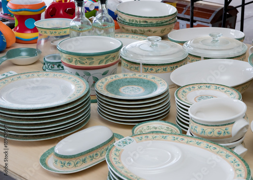 Collection of matching dishes and toys for sale at a garage sale