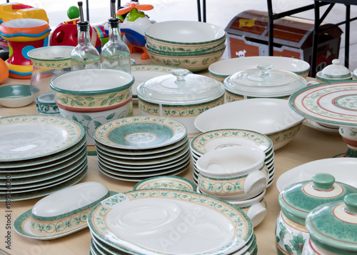 Collection of matching dishes and toys for sale at a garage sale