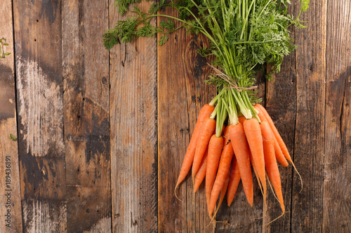 fresh carrot on wood background photo