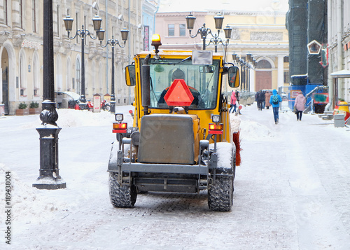 tractor clears snow in the city