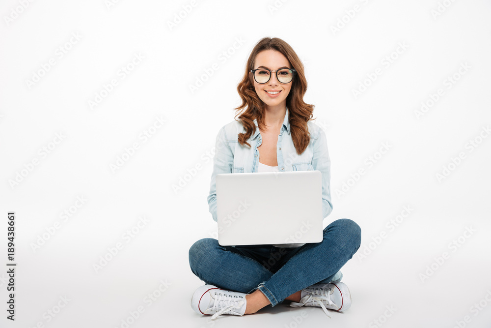Portrait of a smiling casual girl holding laptop computer Portrait of a smiling casual girl holding laptop computer