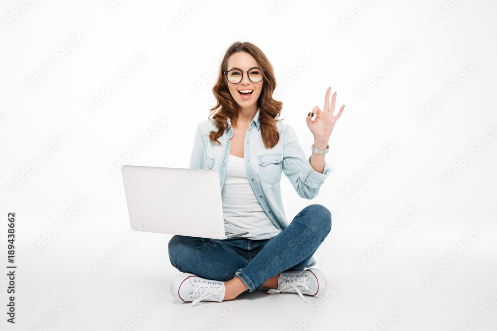 Portrait of a smiling casual girl holding laptop computer Portrait of a smiling casual girl holding laptop computer