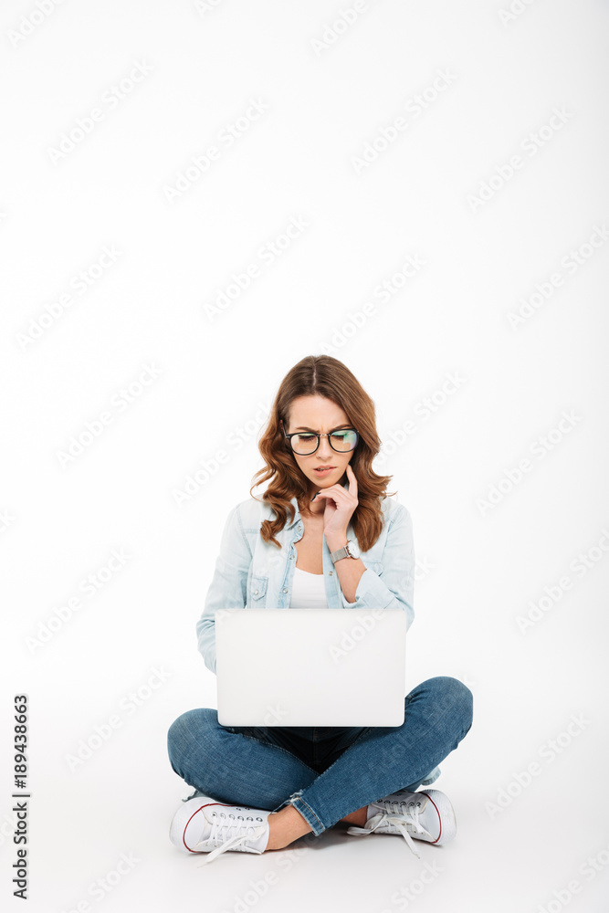 Portrait of a pensive casual girl using laptop Portrait of a pensive casual girl using laptop