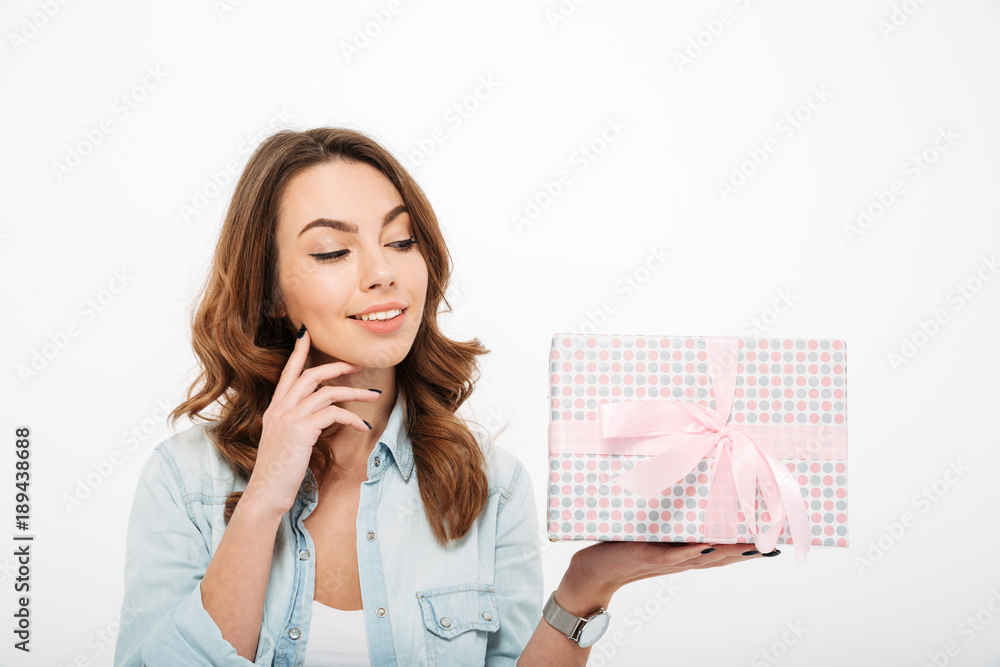 Portrait of a happy casual girl holding present box Portrait of a happy casual girl holding present box